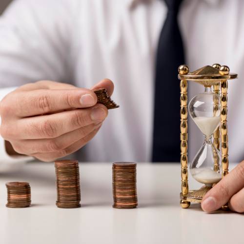 front-view-businessman-with-coins-hourglass (1)