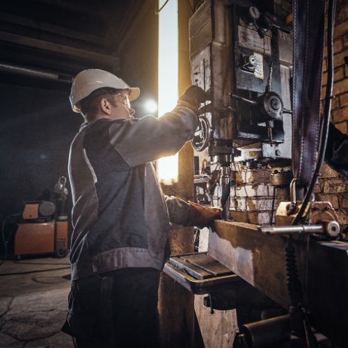 man-is-working-with-giant-drill-busy-metal-factory (1)