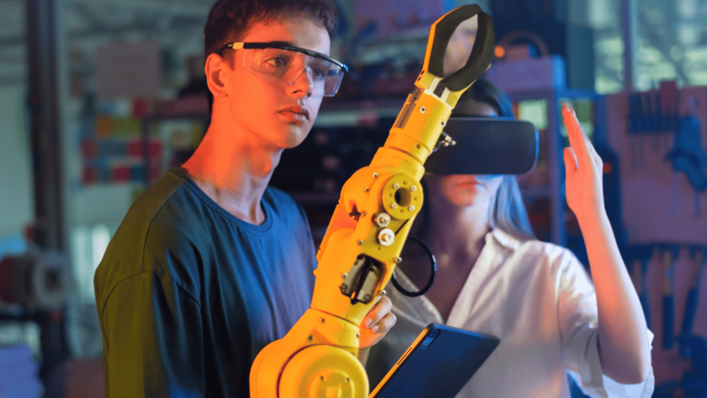 Two engineers using virtual reality and robotic arm for automation and quality control in investment casting.
