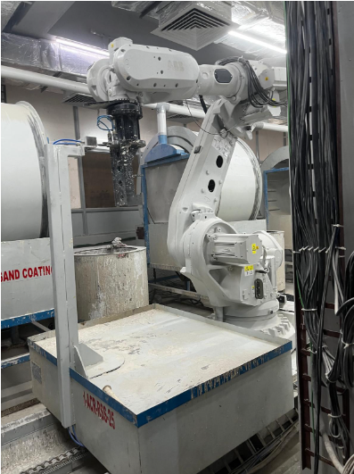 Robotic arm in an industrial setting, used for precision tasks in the investment casting process.