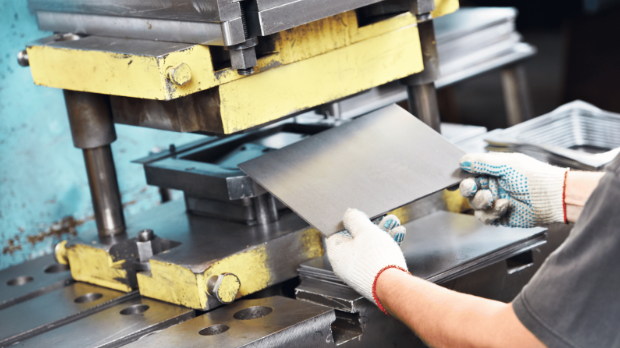 Inserting a metal sheet into a stamping machine for the metal stamping process