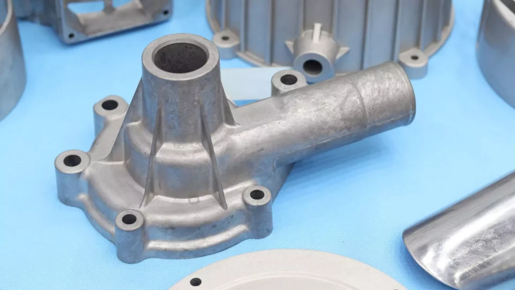 An aluminum cast manifold component with multiple ports and detailed machining for industrial use.