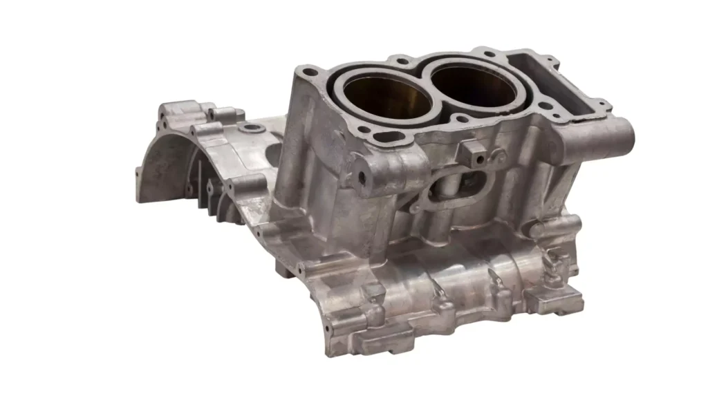 An aluminum engine block cast component with precisely machined cylinder openings and intricate design.