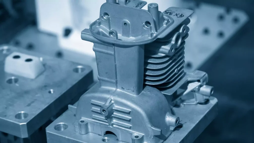 Aluminum engine part manufactured through die casting, showcasing its complex structure and detailed machining.