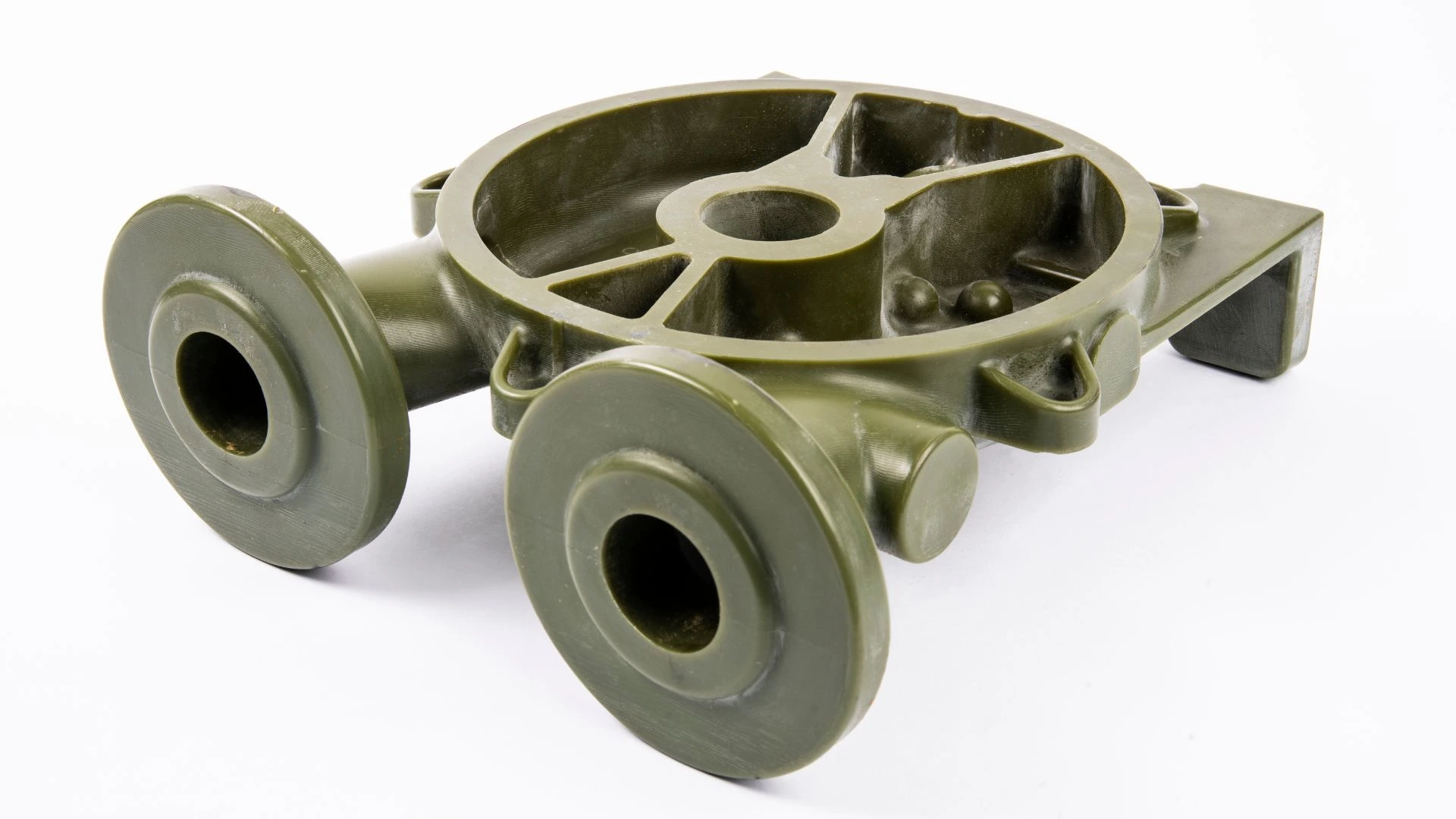 Green resin molded component used in industrial casting.