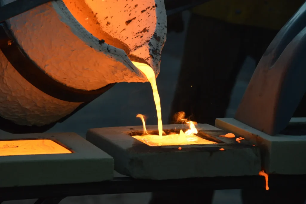 Close-up of molten metal being poured into molds, showcasing the precision in the casting process.