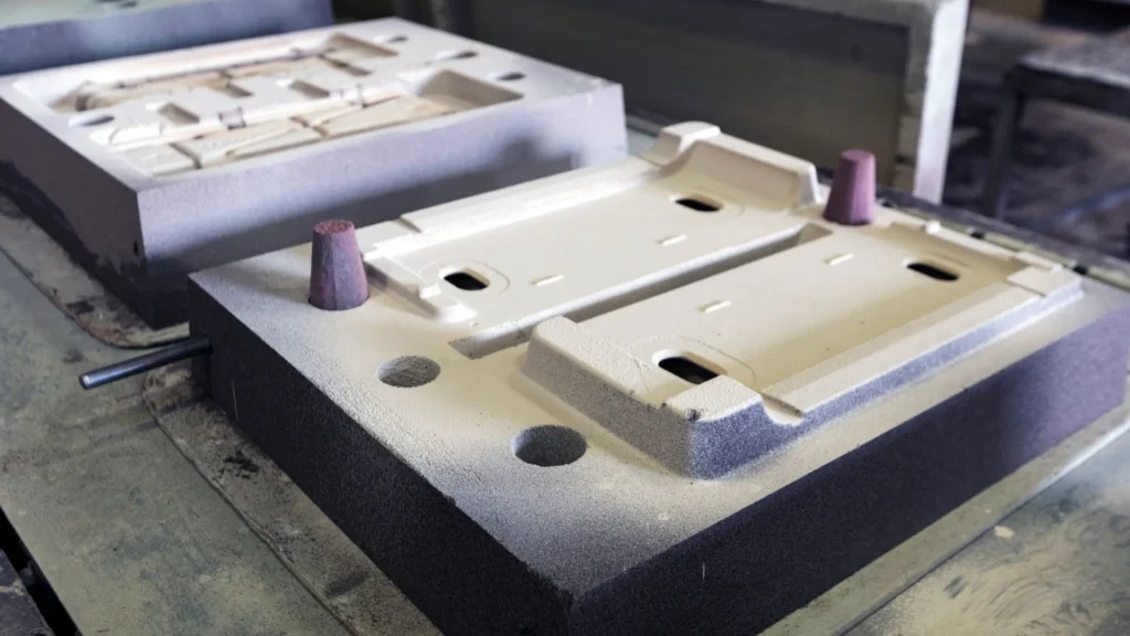 Close-up of a sand mold prepared for casting metal components.